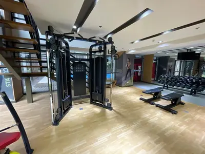 a gym with several treadmills and a staircase at Modern & Luxury 1BR near Okada, Solaire, Airport in Manila