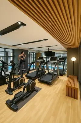 a gym with treadmills and a woman running on a treadmill at Modern & Luxury 2BR near Solaire, Okada, Airport in Manila