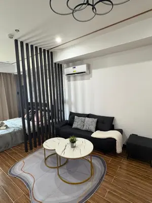 a living room with a couch and a table at Sybaysuites staycation near Okada COD MOA NAIA in Manila