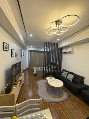 a living room with a couch and a table at Sybaysuites staycation near Okada COD MOA NAIA in Manila