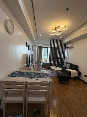 a living room with a bed and a couch at Sybaysuites staycation near Okada COD MOA NAIA in Manila