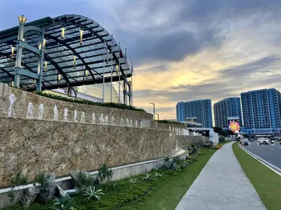 a walkway in front of a city with tall buildings at Modern & Luxury 3BR near Solaire, Okada, Airport in Manila