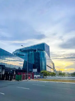 a large glass building on the side of a street at Modern & Luxury 3BR near Solaire, Okada, Airport in Manila