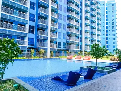 a swimming pool in front of a large apartment building at Modern & Cozy 3BR near Okada, Solaire, Airport in Manila