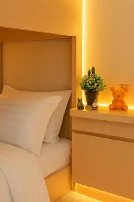 a bedroom with a bed and a potted plant on a shelf at Modern & Cozy 2BR near Okada, Solaire, Airport in Manila
