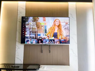 a tv screen hanging on a wall in a bathroom at Modern & Cozy 6BR near Okada, Solaire, Airport in Manila