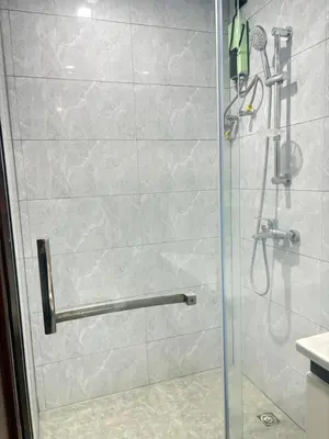 a shower with a glass door in a bathroom at Sybaysuites staycation near Okada COD MOA NAIA airport Solaire MSV1808H in Manila