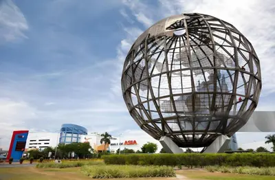 a large metal sphere sculpture in a park at Sybaysuites staycation near Okada COD MOA NAIA airport Solaire MSV1808H in Manila