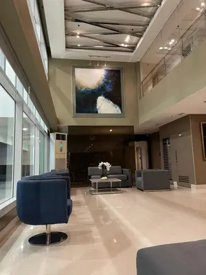 a lobby with chairs and a painting on the wall at Sea Residences Fireworks View - Reynil in Manila