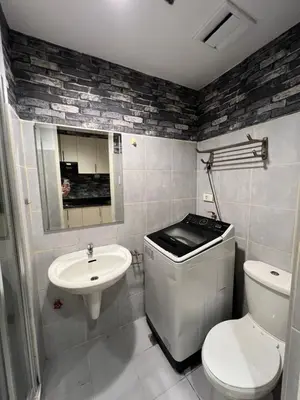 a bathroom with a toilet and a sink at Sea Residences Fireworks View - Reynil in Manila