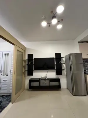 a kitchen with a stainless steel refrigerator and speakers at Sea Residences Fireworks View - Reynil in Manila