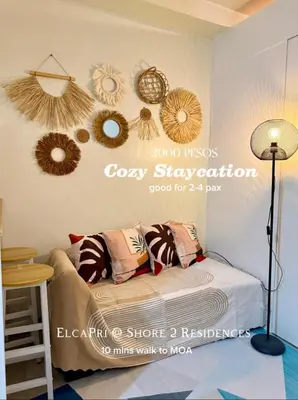 a bedroom with a bed with a sign on the wall at ElcaPri Staycation - Shore 2 Residences in Manila