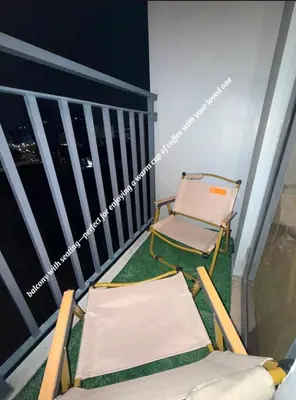 two chairs on a balcony with a view of the city at ElcaPri Staycation - Shore 2 Residences in Manila