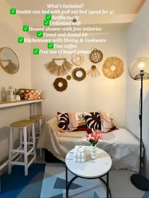 a room with a bed with a table with a table sidx sidx at ElcaPri Staycation - Shore 2 Residences in Manila