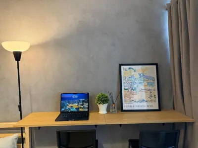 a desk with a laptop computer on top of it at Cozy Studio in Salcedo Village Makati in Manila
