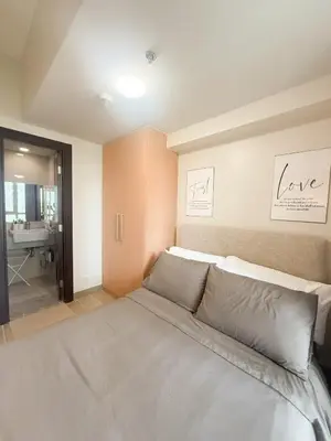 a bedroom with a bed and a bathroom at City View Stay in Uptown BGC in Manila