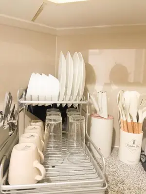 a shelf in a refrigerator filled with dishes and utensils at City View Stay in Uptown BGC in Manila