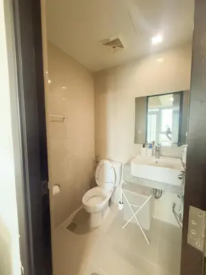 a bathroom with a toilet and a sink at City View Stay in Uptown BGC in Manila
