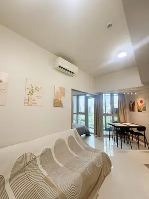a bedroom with a bed and a table with chairs at City View Stay in Uptown BGC in Manila