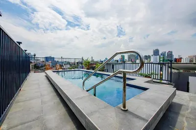 a swimming pool on top of a building at Super OYO Capital O 232 Nest Nano Suites Fort in Manila
