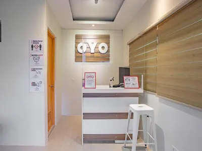 a lobby with a desk with a sign on the wall at The Quarters in Manila