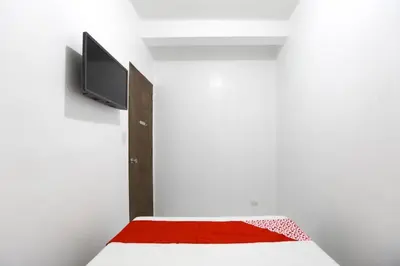 a bedroom with a bed with a red blanket at OYO 736 Jade Apartelle in Cabuyao