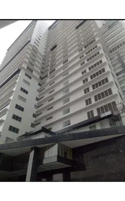 a tall white building with a view of it at Capital O 804 The Residences at Bonifacio Civic Center in Manila
