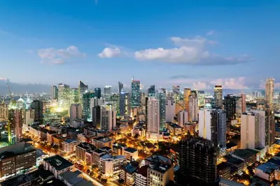 a large city at night with a lot of buildings at Capital O 804 The Residences at Bonifacio Civic Center in Manila