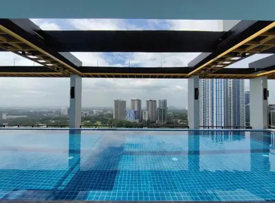 a swimming pool with a view of a city at Capital O 804 The Residences at Bonifacio Civic Center in Manila