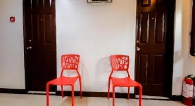 two red chairs sitting next to a wall at City Stay Inns Slex Makati in Manila