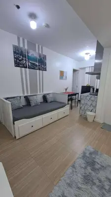 a living room with a bed and a dining room at AZURE BICUTAN MAUI G14 TOWER POOL View in Manila
