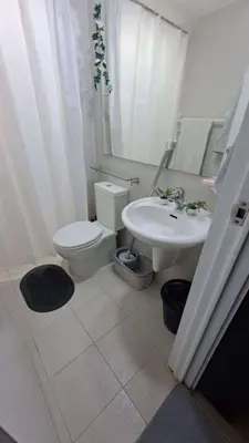 a bathroom with a toilet and a sink at AZURE BICUTAN MAUI G14 TOWER POOL View in Manila