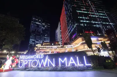 a sign that reads metropolitan openatown mall at night at 1BR condo at One Uptown Residence in BGC in Manila