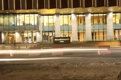 a building at night with a street in front of it at 1BR condo at One Uptown Residence in BGC in Manila
