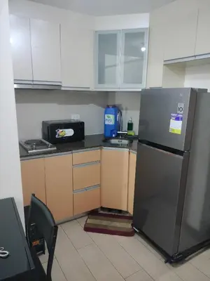 a kitchen with a refrigerator and a microwave at Pasay Condotel Near Airports in Manila