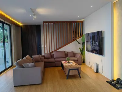 a living room with a couch and a table at The LakeFront Villa in Binangonan