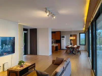 a living room with a couch and a table at The LakeFront Villa in Binangonan