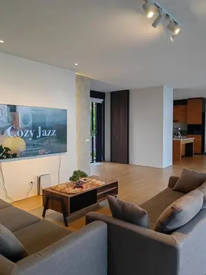 a living room with two couches and a coffee table at The LakeFront Villa in Binangonan