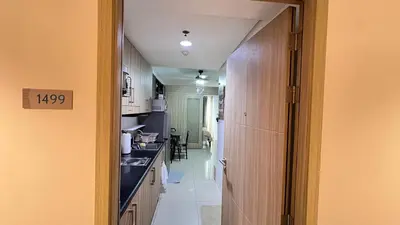 a kitchen with a hallway leading to a dining room at STARR 2050 Vacation Home in Manila