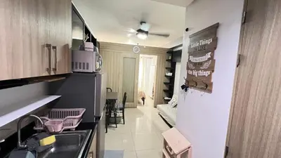 a kitchen with a sink and a refrigerator at STARR 2050 Vacation Home in Manila