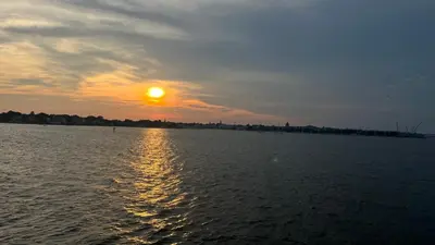 a sunset over a large body of water at STARR 2050 Vacation Home in Manila