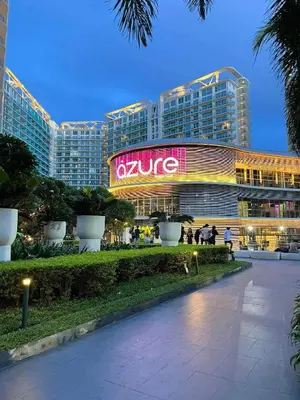 a large building with a sign that reads kulse at 400MBPS! 3Beds 1217 Azure Urban Beach Spa Mall Resto in Manila