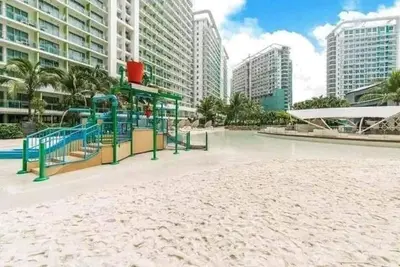 a playground in the middle of a city with tall buildings at 400MBPS! 3Beds 1217 Azure Urban Beach Spa Mall Resto in Manila