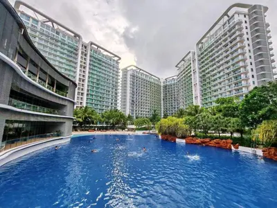 a large swimming pool in front of tall buildings at 400MBPS! 3Beds 1217 Azure Urban Beach Spa Mall Resto in Manila