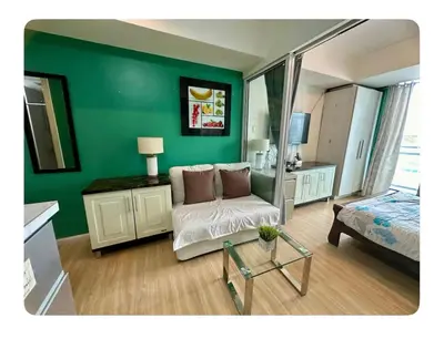 a green room with a couch and a bed at 400MBPS! 3Beds 1217 Azure Urban Beach Spa Mall Resto in Manila