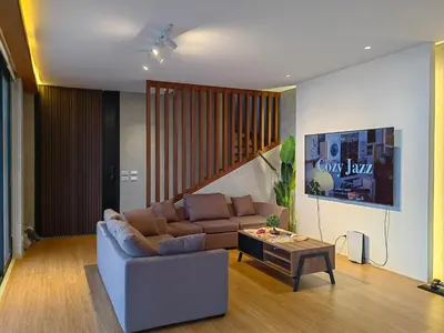 a living room with a couch and a coffee table at The LakeFront Villa in Binangonan