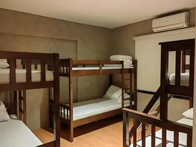 a room with three bunk beds in a room at The LakeFront Villa in Binangonan