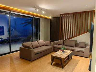 a living room with a couch and a table at The LakeFront Villa in Binangonan