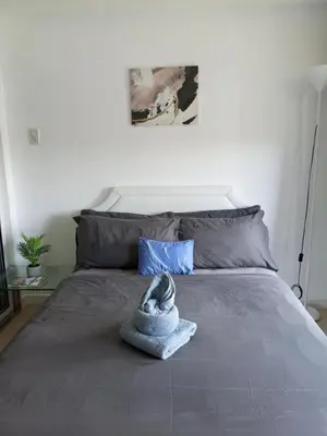 a bed with a stuffed animal on top of it at Azure Urban Resort Residences in Manila