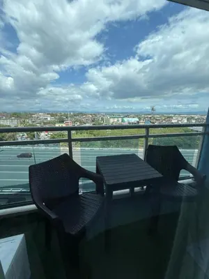 a table and chairs on a balcony with a view at Azure Urban Resort Residences in Manila